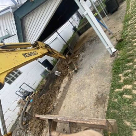 Excavator beside a house