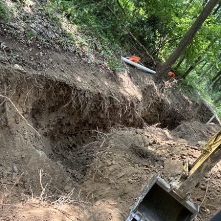 Excavation exposing a sewer connection